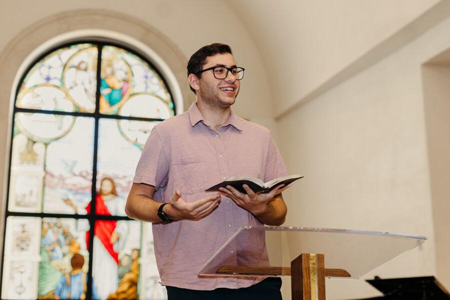 a student from the ministry leadership studies concentration in pastoral ministries program reads from the bible